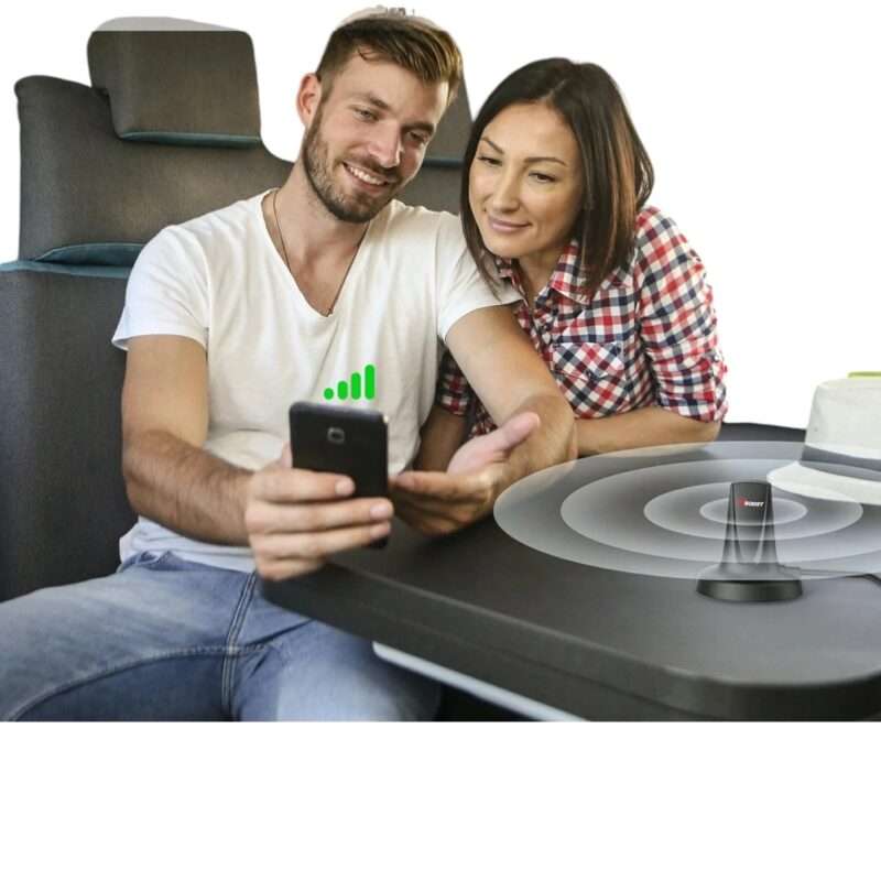 a man and woman sitting at a table looking at a phone