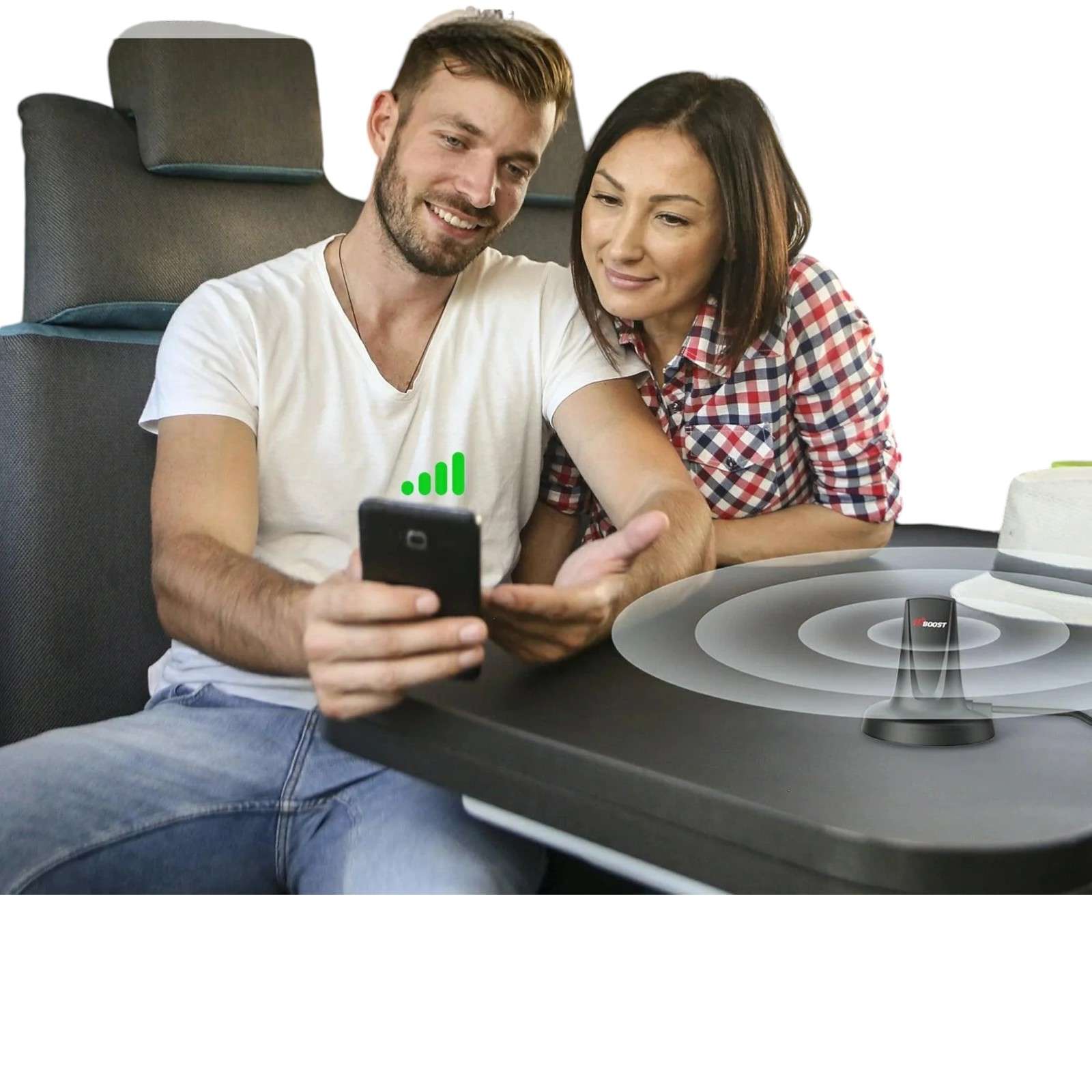 a man and woman sitting at a table looking at a phone